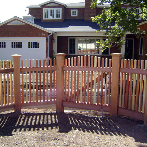Wooden picket fence around yard